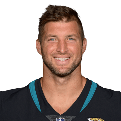 Tim Tebow in 2025 smiling in a suit