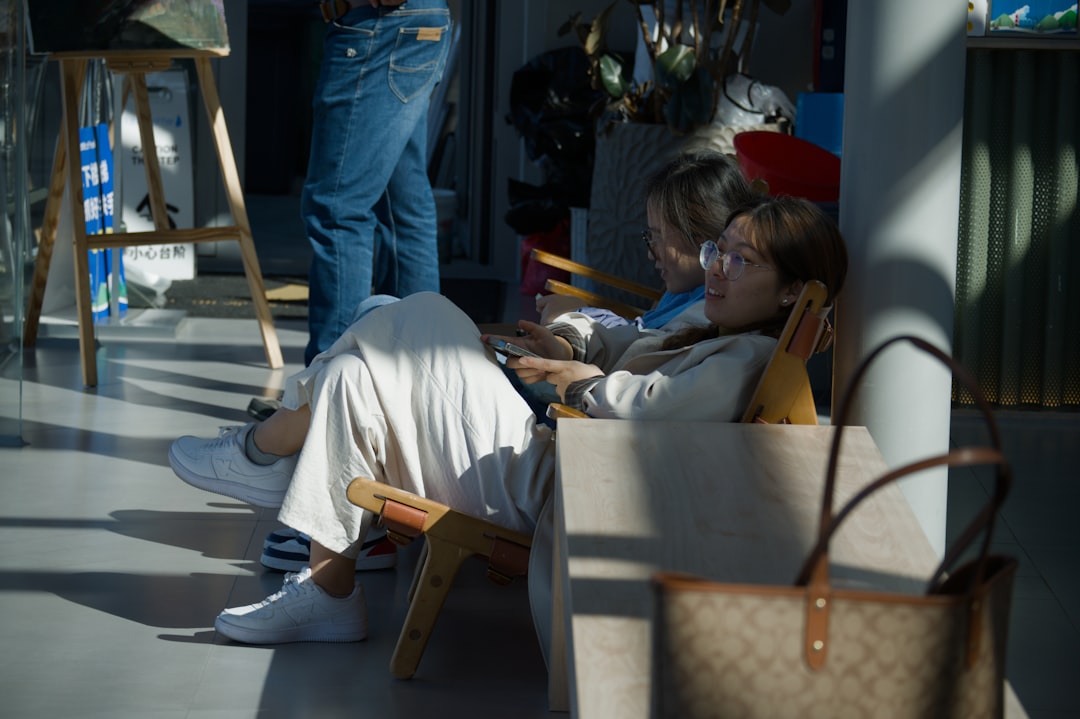 person relaxing on a couch reading while holding a cbd oil dropper